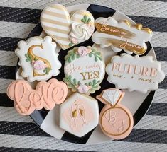 some decorated cookies are on a black and white plate