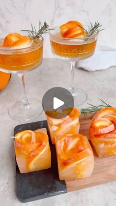 an image of food on a cutting board with wine and oranges in the background