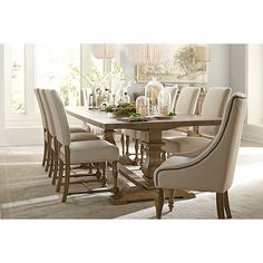 a dining room table with six chairs around it