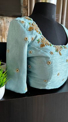 Product Description : Light blue silk blouse comes with heavy detailed and intricate pearl hand works for front & back necks and sleeve as shown. Specification: STITCHED BLOUSE: * Material : Silk * Colour : Light Blue*Blouse length :13-14”(Alterable) * Sleeve Length : 11.5" (Alterable)* Style: Patterned as shown * Works : Threads exclusive detailed and intricate heavy hand works for front & back neck and sleeve as shown. View this post on Instagram A post shared by threadslabel.com (@shobana_nithin) Front Neck Design For Blouse, Blouse Front Neck Design, Front Neck Blouse Design, Blouse Front Neck Designs, Exclusive Blouse Designs, Hand Worked Blouse, Blue Velvet Blouse, Velvet Blouse Design, Blue Silk Blouse