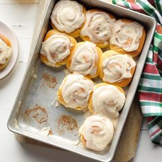 a pan filled with donuts covered in frosting