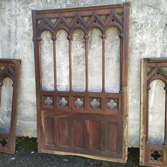 an old wooden door and two mirrors on the ground