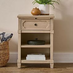 a wooden shelf with a potted plant on top of it next to a wicker basket