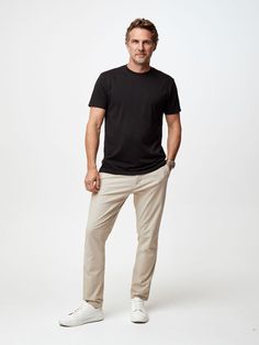 If you love the timelessly cool look of a fitted black tee, then look no further, because our Black Crew Neck is here to help you live your best life. In fact, this shirt's such an all-timer, it's the one that prompted us to start our company in the first place. Features StratuSoft, our super-soft proprietary cotton-poly fabric Side seam ensures the tee looks good on its own or layered Available in both crew neck and v-neck Free exchanges and no-hassle returns Men Black Tshirt Outfits, Tshirt Outfit Men, Black Tee Outfit, Black Tshirt Outfit, Chinos Men Outfit, Plain Black T Shirt, Black Chinos, Tshirt For Men, Basic T Shirts