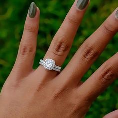 a woman's hand with a diamond ring on it