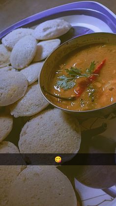 a bowl filled with soup next to some pita bread