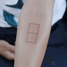 a person with a tattoo on their arm that has a square and rectangle in it