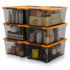 three plastic storage containers stacked on top of each other with books and magazines in them