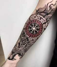 a man's arm with a clock and dragon tattoo on the left inner arm