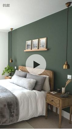 a bed room with a neatly made bed and green walls