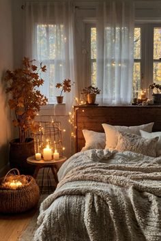 a bedroom with candles and blankets on the bed