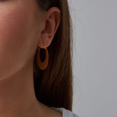 A crescent shaped take on the classic gold hoop or creole earring, drawing influences from both tribal and 1970s jewellery. Hoop earrings are always popular through the decades in various forms and this is an updated and on-trend version drawing on the current tribal trend (with a bit of influence from 1970s Woodstock style!) The half moon shapes are cut from raw brass, giving them their slightly matte gold finish. They are fixed to ear wires with a 45 degree hook-and-hole fastening so they're e Woodstock Style, Tea Cup Jewelry, Storm In A Teacup, 1970s Jewelry, Brass Jewellery, Gold Crescent Moon, Creole Earrings, Contemporary Earrings, Through The Decades