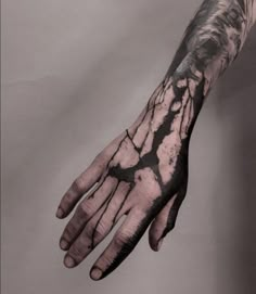 a man's hand with black and white ink on it, showing the structure of his hands