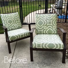 two chairs sitting next to each other in front of a fence