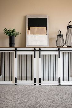 two black and white baskets sitting on top of a shelf