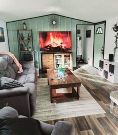 a living room filled with furniture and a fire place in the wall behind the couch