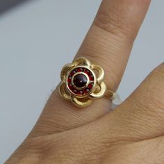 "For sale: (1) d528 14k Yellow Gold Red Stone Flower Ring PLEASE READ ENTIRE DESCRIPTION BEFORE PURCHASING Pre-owned item. Good condition. Please see pictures for details. Sold as is, as seen on pictures. This yellow gold ring is absolutely stunning. It contains eleven (11) beautiful red stones. This ring is stamped. Specifics: 14k Yellow gold Size: 4.5 (U.S.) Ring Dimensions: 12.5 mm x 15 mm Stone Dimensions: 3 mm round Total Weight: 4.7 grams Please be 100% sure of your purchase before buying, Stamped 14k Garnet Ring Jewelry, 14k Stamped Garnet Ring Jewelry, 14k Stamped Garnet Ring, Elegant Gold Flower Ring With Ruby, Gold Flower Ring With Ruby Gemstone, 14k Yellow Gold Garnet Jewelry, Red Flower Ring For Formal Occasions, Red Flower Shaped Jewelry For Formal Occasions, Red Flower Shaped Formal Jewelry