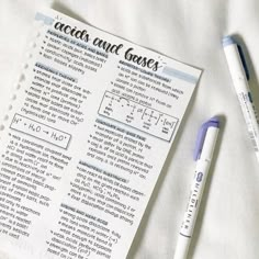 a pen and some paper on top of a white sheet with words written in it