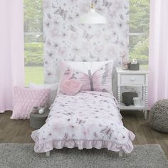 a bedroom with pink and white decor in the corner, including a butterfly themed wallpaper