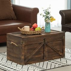 a wooden trunk sitting on top of a rug