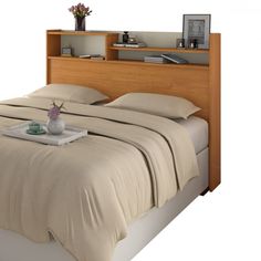 a bed with a wooden headboard and beige sheets