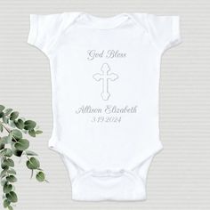 Your little child will look great and feel great wearing this Personalized Christening Infant bodysuit. A wonderful addition to your baby's Christening attire which makes a lasting Personalized Keepsake for years to come. Our Personalized Christening Infant bodysuit is available on our premium 5oz, 100% white cotton Personalized Infant bodysuit with crew neck, double-needle hemmed sleeves and binding at the legs with three snap bottom. Machine washable in infant sizes NB-18 mos. Christening body White Short Sleeve Onesie For Baptism, Personalized White Baptism Dress, Personalized Fitted Onesie For Baptism, Fitted White Onesie For Baptism, White Fitted Onesie For Baptism, Baby Baptism Gifts, Alyssa Marie, Communion Decorations, Baptism Outfit