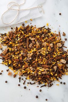 a pile of food sitting on top of a white counter next to a napkin and spoon