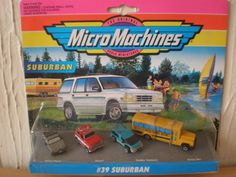 a toy car set in the packaging for micro machines suburban, with other cars and trucks