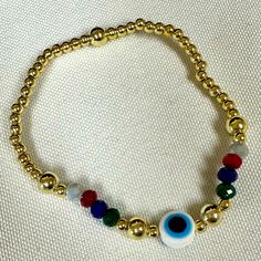 Evil Eye Elastic Bracelet With Colorful Crystal And Gold Filled Balls Brand New Adult Size Center Evil Eye Gold Filled Balls On Each Side Of Evil Eye Casual Gold Beaded Bracelets For Party, Casual Gold Stretch Bracelet With Colorful Beads, Trendy Gold Crystal Bracelet With Colorful Beads, Casual Gold Bracelets With Colorful Beads, Multicolor Beaded Bracelet With Evil Eye, Casual Handmade Gold Crystal Bracelet, Spiritual Gold Charm Bracelet With Colorful Beads, Rainbow Casual Jewelry For Party, Casual Rainbow Jewelry For Party