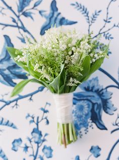 a bouquet of flowers sitting on top of a blue and white wall