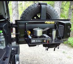 the back end of a truck with an open camper