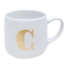 a white and gold coffee cup with the letter c on it