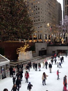 people skating on an ice rink in front of the rockefeller christmas tree