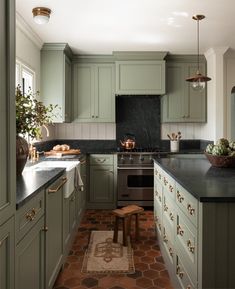 an instagram photo of a kitchen with green cabinets