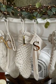 gold mirror ornament letters, white crochet stockings, knitted white christmas stockings, christmas ornaments, mantle decor, ivy garland, white fireplace Christmas Stocking Name Ideas, Christmas Stocking No Fireplace, White Christmas Stockings Ideas, Stocking Mantle, Elegant Letters, Gold Christmas Stockings, Mirror Letters, Christmas Stocking Decorations, Gold Mirror Acrylic