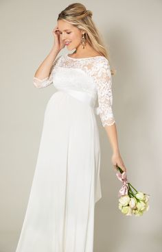 Fall in love with our classic yet ultra-modern maternity bridal gown, Olivia. Designed with the softest ivory stretch lace on the bodice and a silky soft sheen jersey to the skirt. Scallop edging adorns the v-back lace neckline and sleeves whilst the upper bodice is left elegantly sheer. With an empire line waist and gentle gather and stretch for the perfect fit, you will glide down the aisle in both comfort and style. Sheer floral lace with subtle stretch Lightweight silky satin jersey skirt Sc Fitted Maternity Dress With Sweep Train For Wedding, Fitted Maternity Wedding Dress With Sweep Train, Elegant Lace Maternity Wedding Dress, Elegant White Maternity Dress With Lace Trim, Elegant Maternity Wedding Dress With Lace Trim, Elegant Wedding Maternity Dress With Lace Trim, Fitted Maternity Dress With Lace Sleeves, Elegant White Maternity Dress For Bridal Shower, Fitted Lace Maternity Dress For Wedding