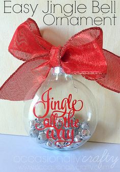 a christmas ornament with the words, easy jingle bell on it and a red bow