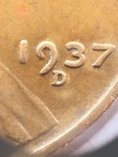 a close up of a coin with the number twenty seven on it's side