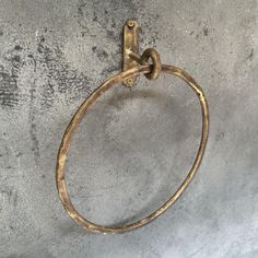 an old brass towel ring hanging on a wall