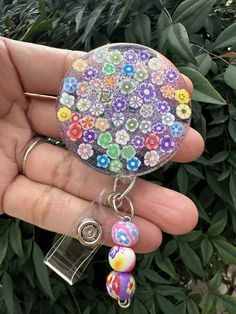 This bold and bright flower badge reel  is showing off some purple shine in such a bold way!  These make super fun and useful gifts for any person in any profession. A great gift choice for nurses, medical staff, office staff, and anyone who is required to wear a badge. Hand made with purple glitter, resin, and design printed to make it waterproof. Each design is handmade so each badge we make will look slightly different than the next.  *Glitter background can be made with many different shades Resin Badge, Useful Gifts, Teacher Badge, Office Staff, Medical Staff, Outdoor Photos, Glitter Background, Bright Flowers, Purple Glitter