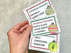 two christmas themed candy bar wrappers being held up by someone's left hand