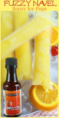 a bottle of boozy ice pops next to sliced oranges and pineapple slices