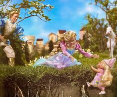 two dolls are playing with each other in the grass and one doll is laying on the ground