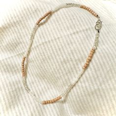 "3 tone beaded necklace that loosely sits right at the base of the neck. Its neutral tones allow it to be paired with everything in your closet! This is made with a tan/khaki brown, clear and white seed beads. It is closed with a lobster clasp and will include a small chain for adjustable wear.  It is sized at 17\" from clasp to loop but with the added chain it will allow up to another 2\".  If you have any questions or would like to customize this look please feel free to reach out!  Thank you for supporting our small family business ❤️" Small Family, Family Business, Neutral Tones, Lobster Clasp, Seed Beads, Necklace Etsy, Beauty Book, Etsy Accessories, Beaded Necklace