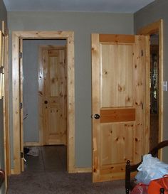 an empty room with two wooden doors in it