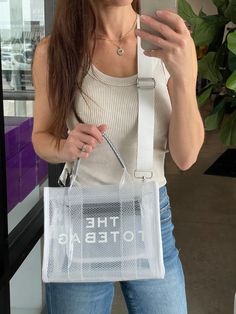 This inspired CLEAR tote bag will be the prefect accessory for all things concert, stadium events, and sporting events this summer (or any time of year). Adjustable strap Easy to clean 10.63" x 4" x 8.27" Preorder items will ship approx 14 business days from order. Trendy Mesh Bag For Daily Use, Trendy Rectangular Mesh Bag, Trendy Rectangular Mesh Bags, Casual Mesh Tote Bag, Rectangular Mesh Bag For Everyday Use, Everyday Rectangular Mesh Bag, Summer Mesh Bag For Daily Use, Mesh Bags For Daily Use In Summer, Large Capacity Mesh Bag For Summer