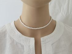 "This White Beaded Choker is so simple and elegant. It can wear alone or layer with other chokers, in any case, it is perfect for any outfit. This listing for ONE WHITE CHOKER. DETAILS - Japanese glass seed beads 4 mm - Quality strong nylon string - Choker length. Choose in the drop down menu - Lobster or round clasp closure. Available gold tone (default) or silver tone (by request) - Extension (adjustment) is 1 inch (2.5 cm). If you need longer, please, leave a note when ordering - Comes in a s White Single Strand Beaded Necklaces For Summer, White Choker With Tiny Round Beads, White Tiny Beaded Choker, White Minimalist Beaded Necklace With Tiny Beads, Simple White Jewelry With Tiny Beads, Minimalist White Beaded Necklace With Tiny Beads, Simple White Round Beads Jewelry, Simple White Round Bead Jewelry, Simple White Round Beaded Jewelry