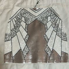 a white and brown skirt with sequins on it