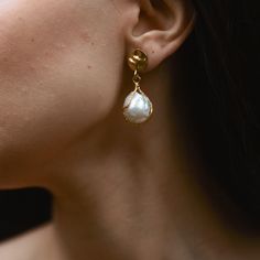 These handmade dangling pearl earrings are made of 22k gold-plating on brass. These  statement earrings, combined with the freshwater pearl, create a timeless and sophisticated look and are truly one-of-a-kind. In these real pearl dangle earrings, beautiful freshwater pearl is  carefully caged.  Designed for everyday comfort, these minimalist earrings are suitable for any occasion. Whether it's a casual outing or a special event, these delicate earrings are sure to enhance your style. Upon your request, this product can be purchased as a set with the bracelet available in my store. The link to the bracelet is as follows. https://www.etsy.com/listing/1519717901/handmade-dangling-pearl-earring-real?click_key=bbfcc19246c034af27ad10defd900d233f183616%3A1519717901&click_sum=aecca6ae&ref=shop_ho Gold Pear-shaped Bridal Earrings With Pearl Charm, Gold Teardrop Pearl Earrings As A Gift, Gold Teardrop Pearl Earrings For Gift, Gold Drop Bridal Earrings With Pearl Charm, Brass Pearl Earrings As A Gift, Brass Pearl Earrings With Pearl Charm As Gift, Pearl Charm Earrings In Brass As A Gift, Gold Plated Teardrop Pearl Earrings For Gift, Gold Teardrop Earrings With Pearl Drop For Anniversary