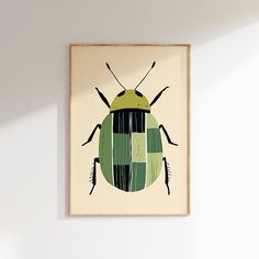 a green and black bug is hanging on the wall